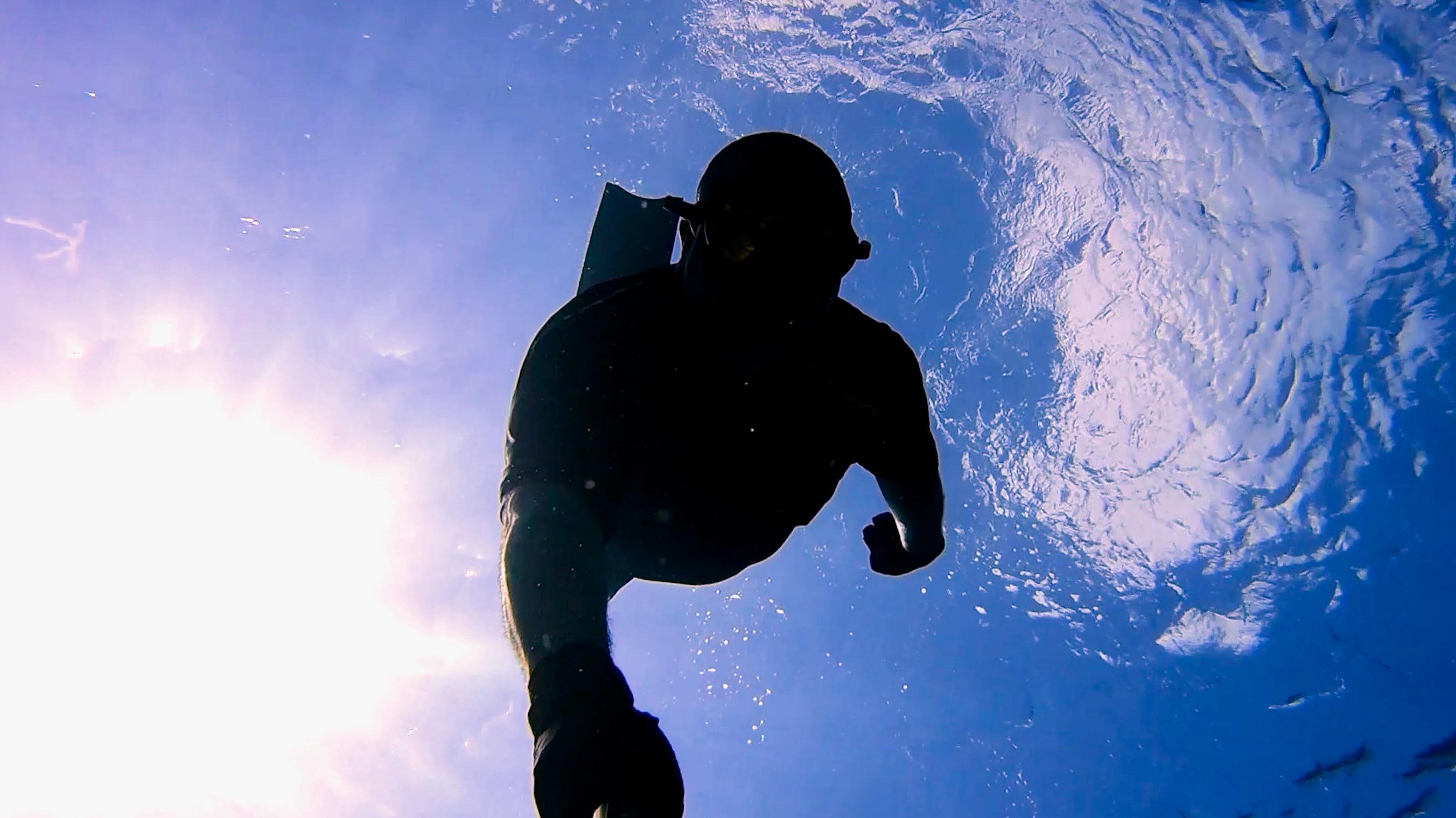 Diving down, between the sun and clouds. Exploring Isla Cozumel